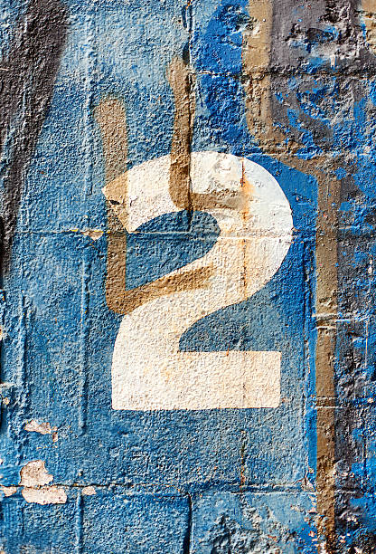istock Number two painted in white against a blue background 2240340750
