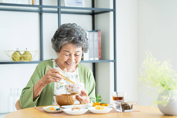 istock Senior woman eating breakfast 2240344393