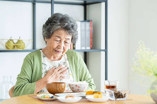 istock Senior woman eating breakfast 2240344419