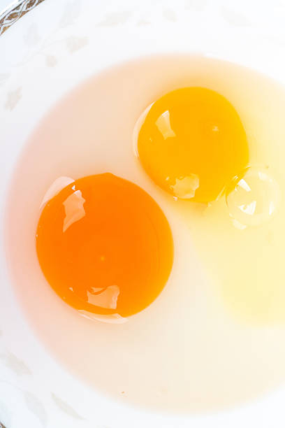 istock Duck egg yolk and chicken egg yolk together in one bowl on white background 2240344660