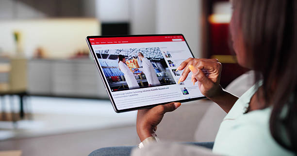 istock African American Woman Browsing News Articles On Tablet 2240345990