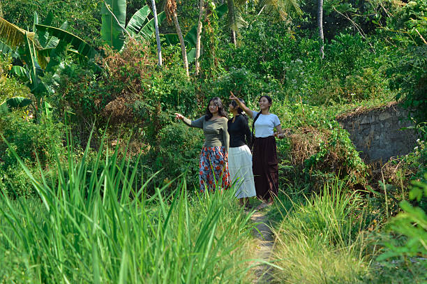 istock Three girls pausing to look and point at distant scenery 2240346551