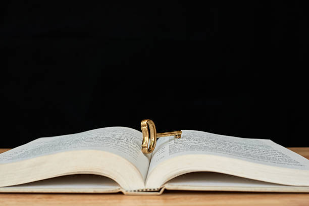 antique key resting in between of open book