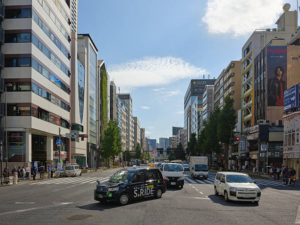 Tokyo, Japan - October 10, 2025: A taxi driving through an intersection in the Hamamatsucho area of Tokyo Japan.