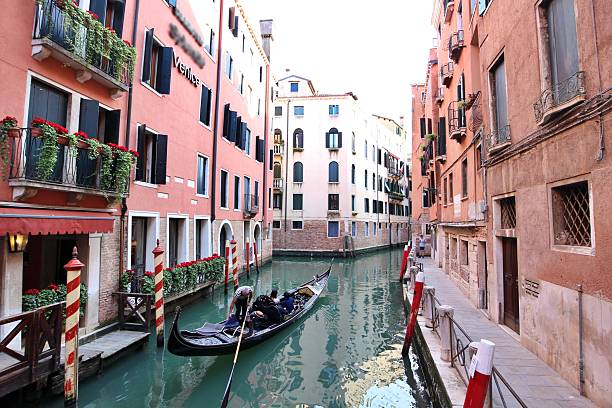 A gondola passing through the canal in the San Marco district of Venice city, Veneto region, Italy - May 2, 2025