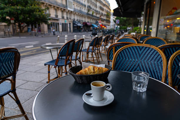 istock Parisian cafe table with coffee and croissant 2240360660