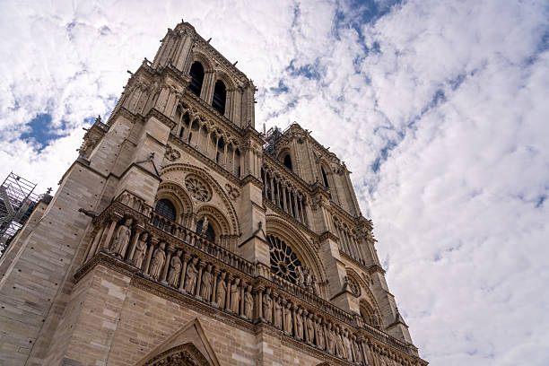 istock Notre Dame Cathedral facade with scaffolding under cloudy sky. 2240361505