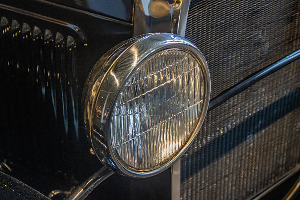 A head light on an old vintage automobile.