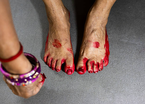 married woman's feet with red dye for religious celebration