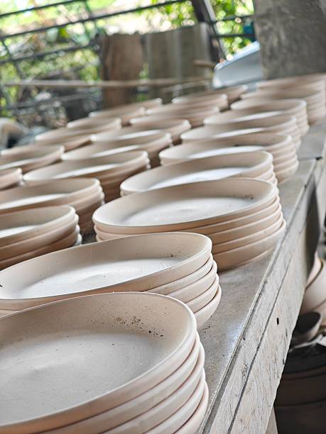 istock Raw pottery blanks stacked on rack at ceramic factory. 2240366750