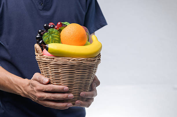Fresh and Colorful Fruit Basket Held by a Person's Hands