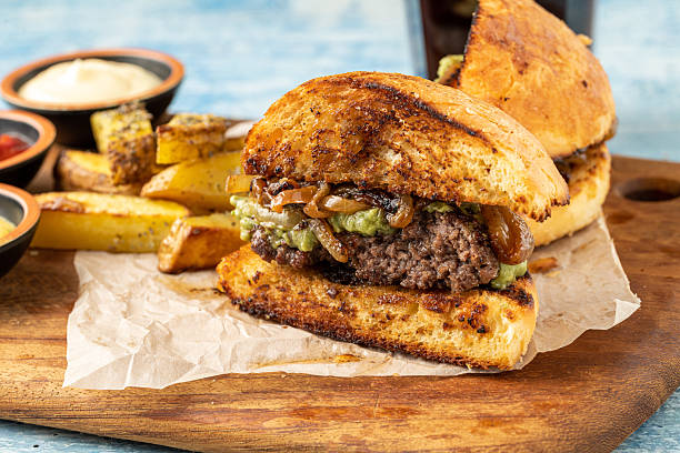 istock Smash burger with cheddar cheese and caramelized onions, served with fries 2240367827