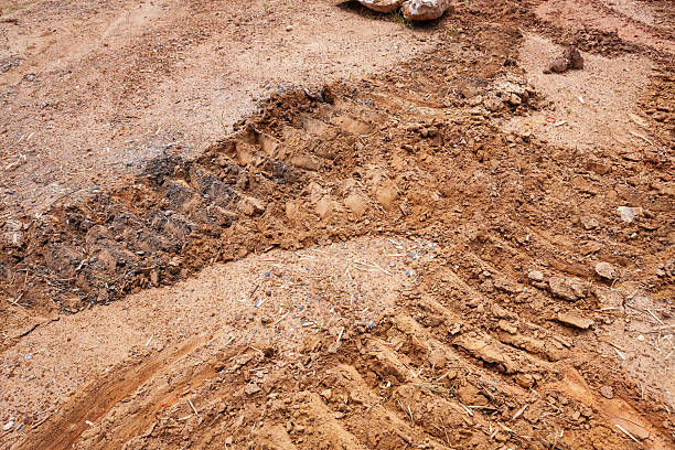 istock Construction progress heavy machinery tracks in soil outdoor site groundwork details close-up view industrial concept 2240368170