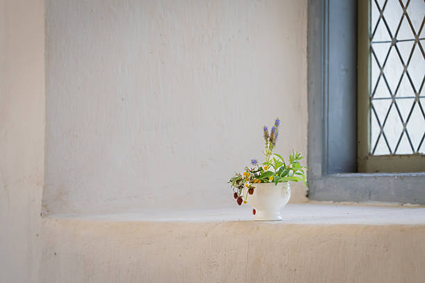 istock Floral arrangement on a church window sill. 2240374581