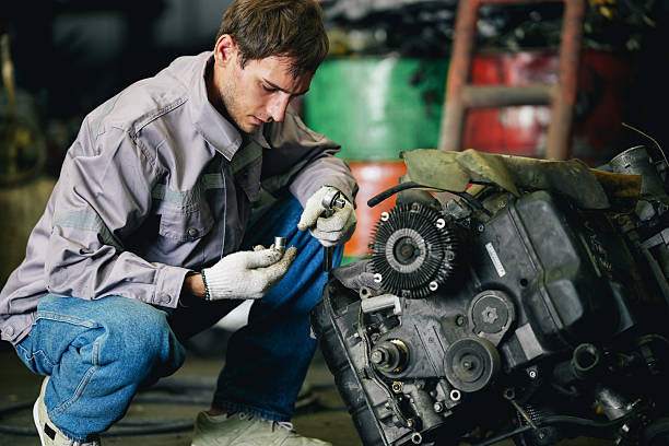 istock Maintenance engineer inspecting rust oily auto motor old spare part in junkyard for reuse service 2240377312