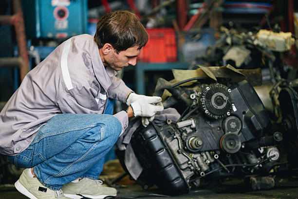 istock Maintenance engineer inspecting rust oily auto motor old spare part in junkyard for reuse service 2240377315