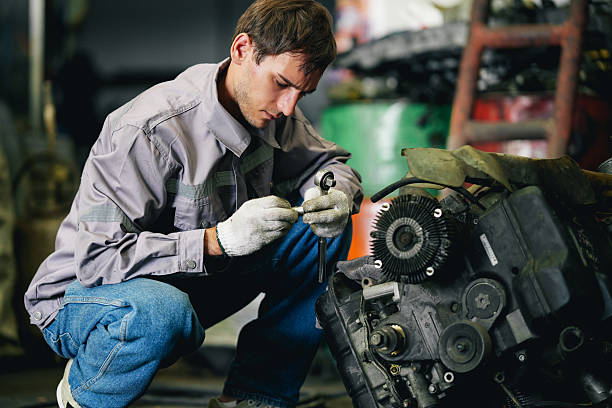 istock Maintenance engineer inspecting rust oily auto motor old spare part in junkyard for reuse service 2240377332