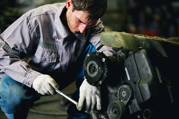 istock Maintenance engineer inspecting rust oily auto motor old spare part in junkyard for reuse service 2240377360