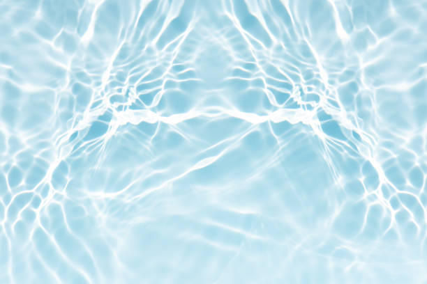 istock Blue water with ripples on the surface. Defocus blurred transparent blue colored clear calm water surface texture with splashes and bubbles. Water waves with shining pattern texture background. 2240378228