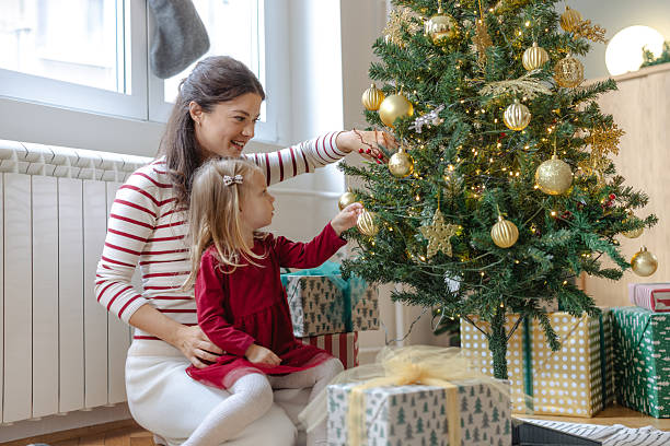 istock Mother and daughter decorating a Christmas tree 2240381295