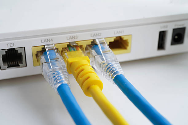 istock Ethernet cable with wireless router connect to internet service provider network. 2240383359