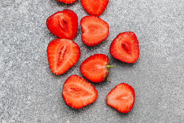 istock Freshly sliced strawberries on a gray surface ready for a delicious treat 2240383758