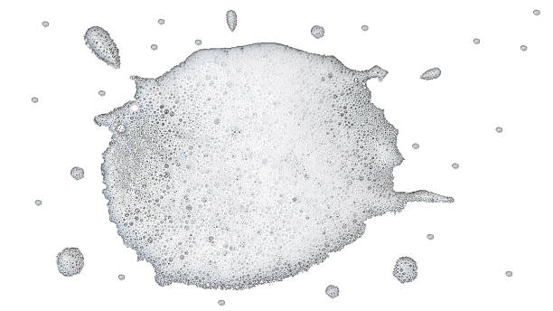 istock High-key abstract photograph layer white foam or suds spreading across bottom portion white background. Foam composed numerous tiny delicate bubbles textured slightly frothy appearance 2240384110