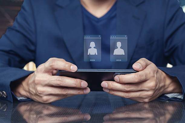 istock Person Using Smartphone for Video Call with Two Profiles on Screen 2240384301
