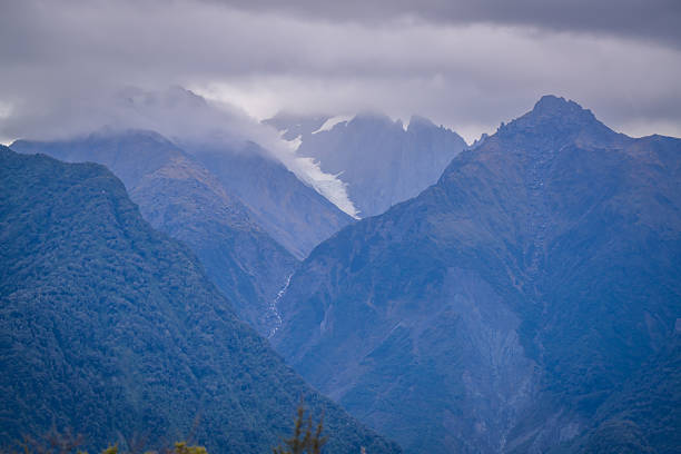 beautiful nature walking tract people can see big trees ,frens ,moss ,reflection lake ,group of duck, animals , colorful mushroom   and fox glacier view at lake Matheson South Island New Zealand