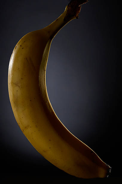 istock Banana fruit photographed in portrait orientation with strong side light 2240388530