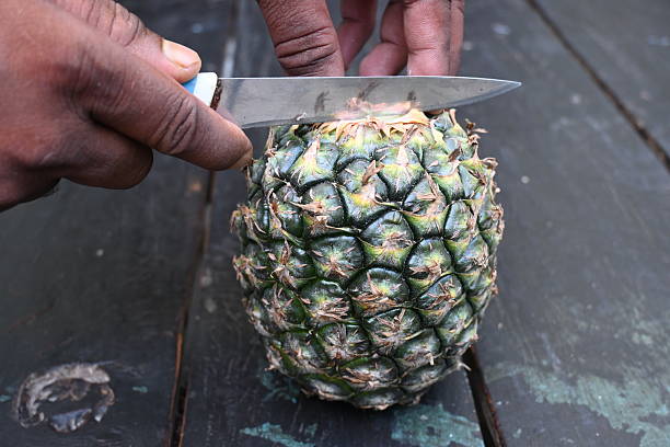 istock Peeling a Pineapple or Ananas comosus with knife. 2240390648