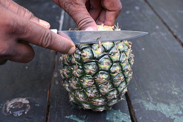 istock Peeling a Pineapple or Ananas comosus with knife. 2240390863