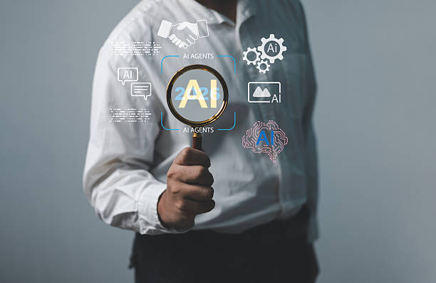 istock Businessman holding magnifying glass AI 2026 interface artificial intelligence surrounded digital icons, symbolizing teamwork, automation, AI agents collaboration business innovation and data strategy 2240397167