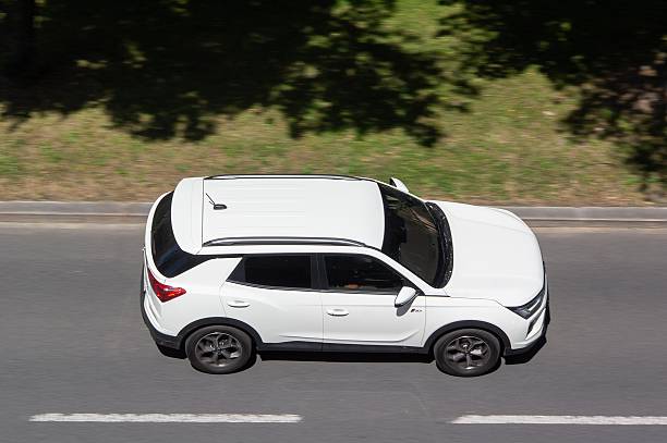 Ostrava, Czechia - June 25, 2025: White SsangYong Korando IV C300 SUV car, top side view with motion blur