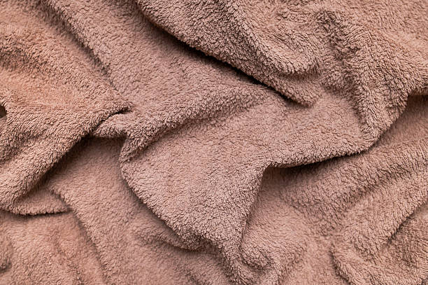 istock Brown cotton towel texture close-up. Crumpled natural fluffy material, beige crumpled background. Bath or beach towel for hygiene, spa, top view. Eco-friendly fabric 2240405802