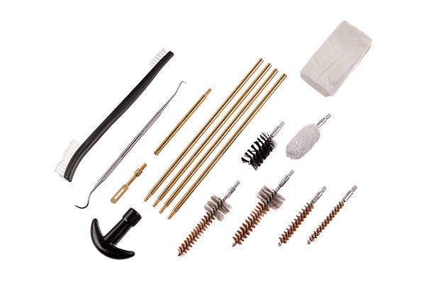 istock Full array of firearm cleaning tools, including brushes, rods, and a patch cloth, laid out on white. 2240409020