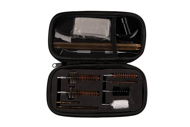 istock Full array of firearm cleaning tools, including brushes, rods, and a patch cloth, laid out on white. 2240409023