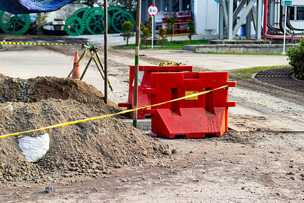 istock Outdoor construction site showcases safety barriers, and caution tape on ground surface. 2240409748