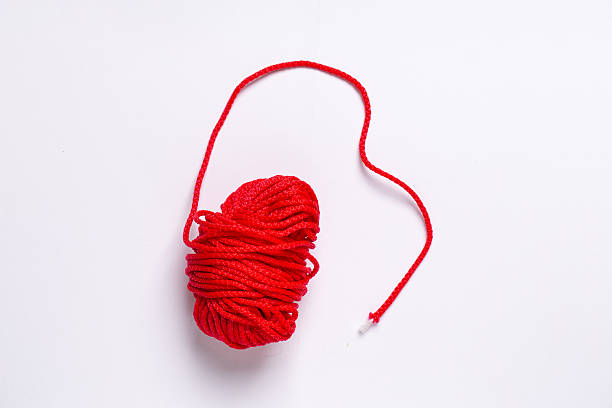 istock A ball of red thread for knitting and sewing on a white background 2240409782