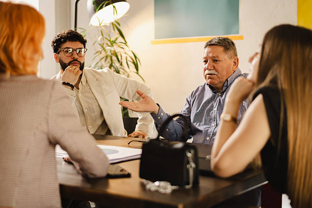 istock Group discussion in a modern office setting with professionals engaged in deep conversation during a meeting in the afternoon 2240412859
