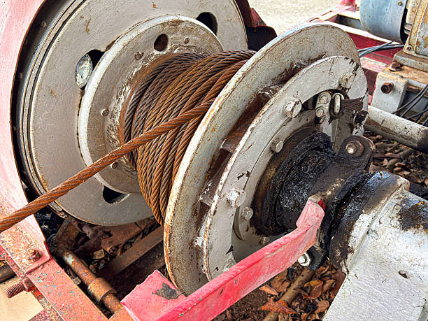 The old pile driving machine was dirty with oil and grease strains .