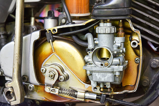 close up view of old carburetor of 2- stroke motorcycle engine . dirty carburetor of motorcycle need to maintenance .