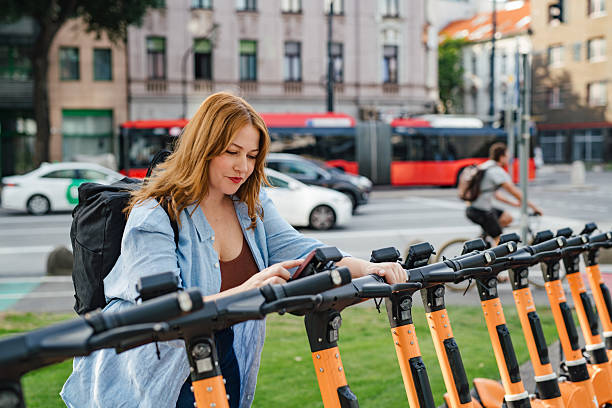istock Curvy woman unlocking shared e-scooter in city. 2240423546