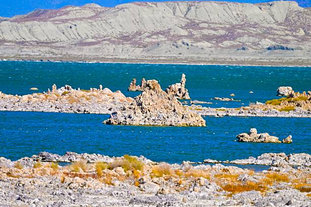 Black and white image of a body of water with rocky spires rising from the water