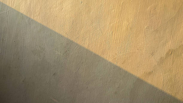 istock diagonal shadow of natural sunlight on a beige wall surface with subtle texture 2240426753