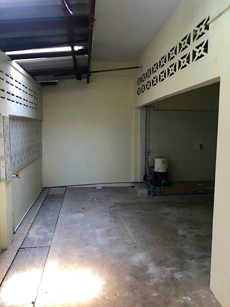 istock Empty utility room with concrete floor and pipes 2240427165