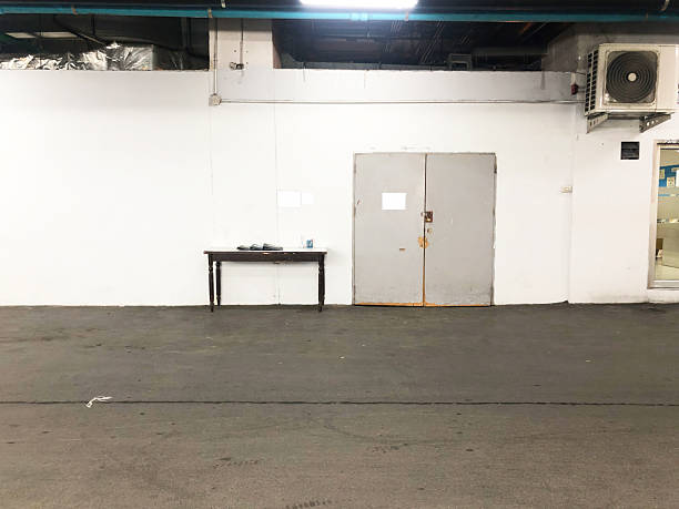 istock Industrial hallway with double doors and table 2240427239