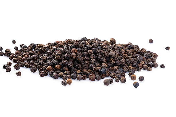istock Black peppercorns on white background 2240436552