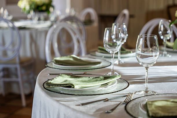 Elegant wedding banquet hall table setting with decorative glassware and linens