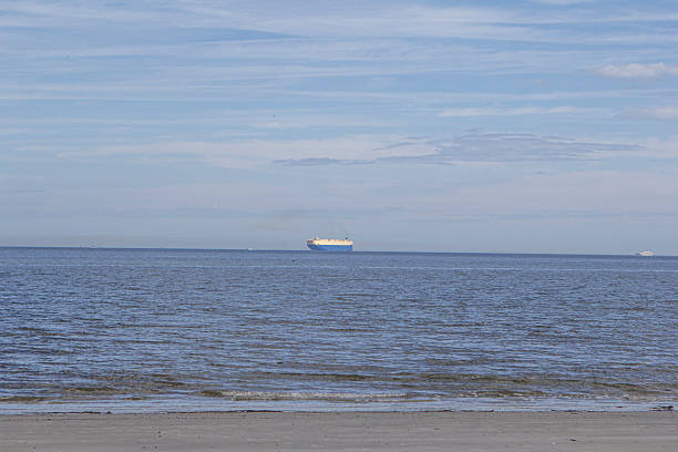 Great water view of a shipping container ship on Georgia's coastline.
